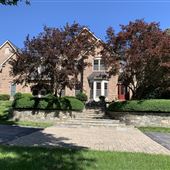 Elevated stately brick front home on a lovely two-acre lot.